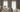 Living room with light gray walls, floor-to-ceiling curtains, a gray sofa with cushions, and a beige sofa with throw blanket around a wooden coffee table.